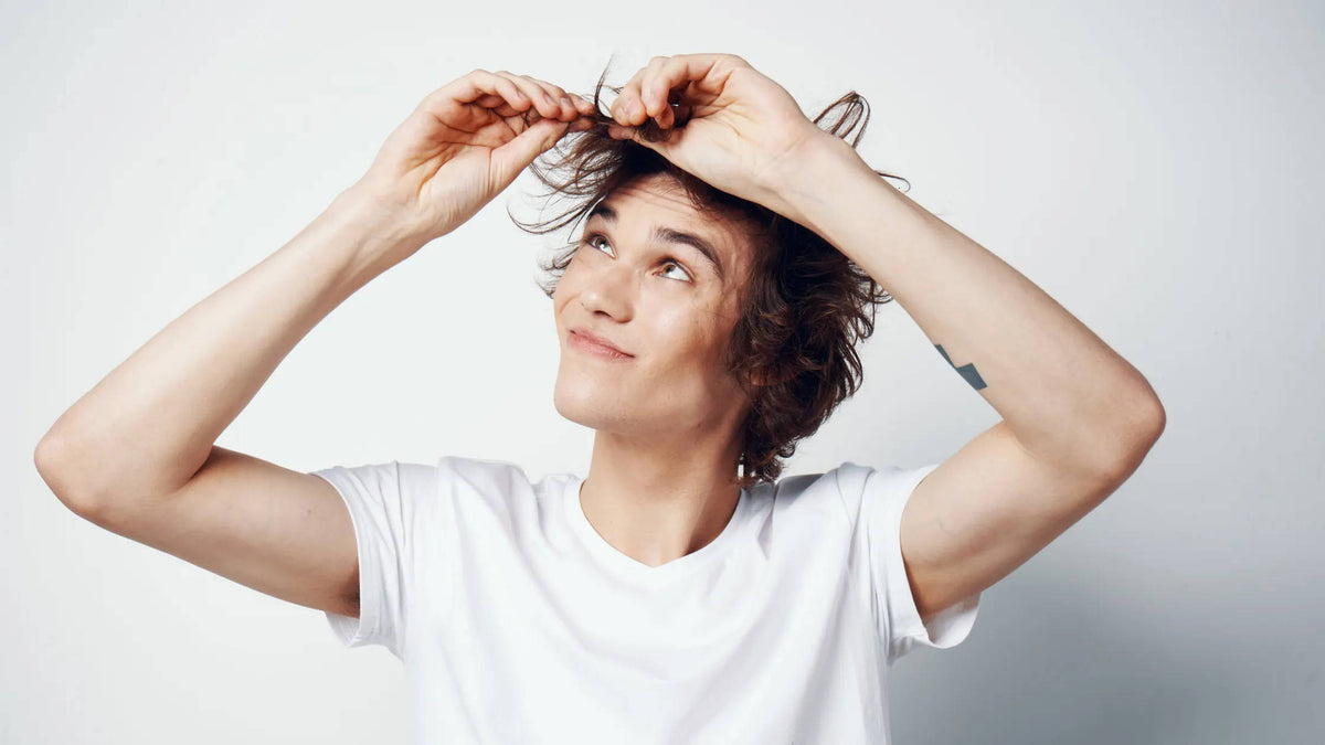 Close-up of a person examining their hair for split ends and damage